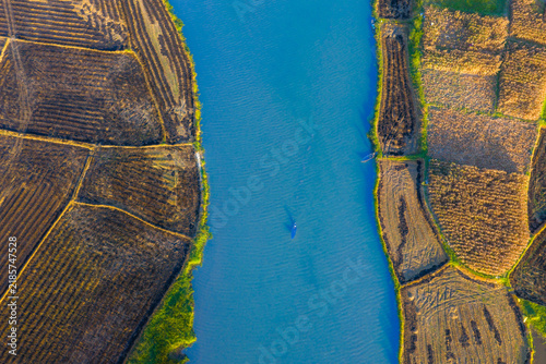 Aerial view of a winding river and harvested crop fields in the countryside of Quang Ngai, Vietnam