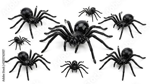 Set of black plastic toy spiders isolated on white background.