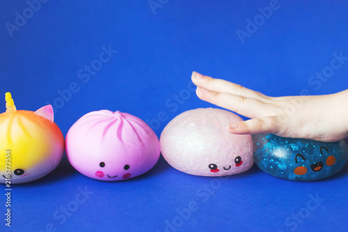 Obraz na płótnie Child hand playing with colorful squishy stress toys