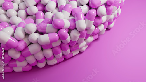 Pile of pink and white capsule pills on pink background