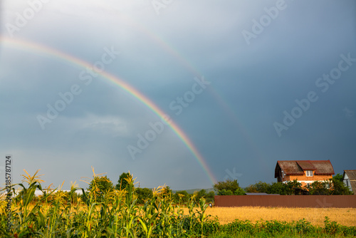 Photography Bright colorful rainbow after the passage of a thunderstorm over the Transylvanian countryside, central Romania