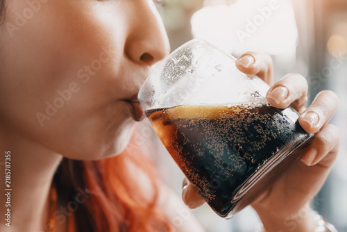 Obraz na płótnie Woman hydrating and enjoying a cold soda drink