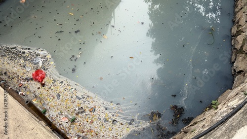 Cuadro en lienzo polluted stagnant urban drainage river with dirty trash and greasy texture water