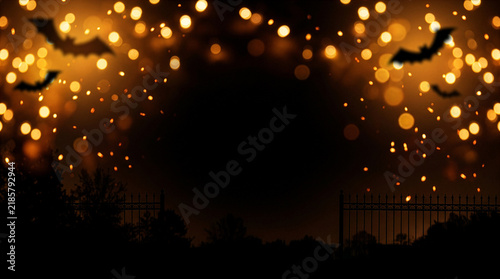 Atmospheric Halloween night background with amber bokeh and bat silhouettes