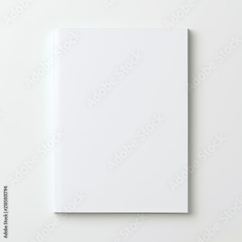 A blank white book cover rests on a white surface