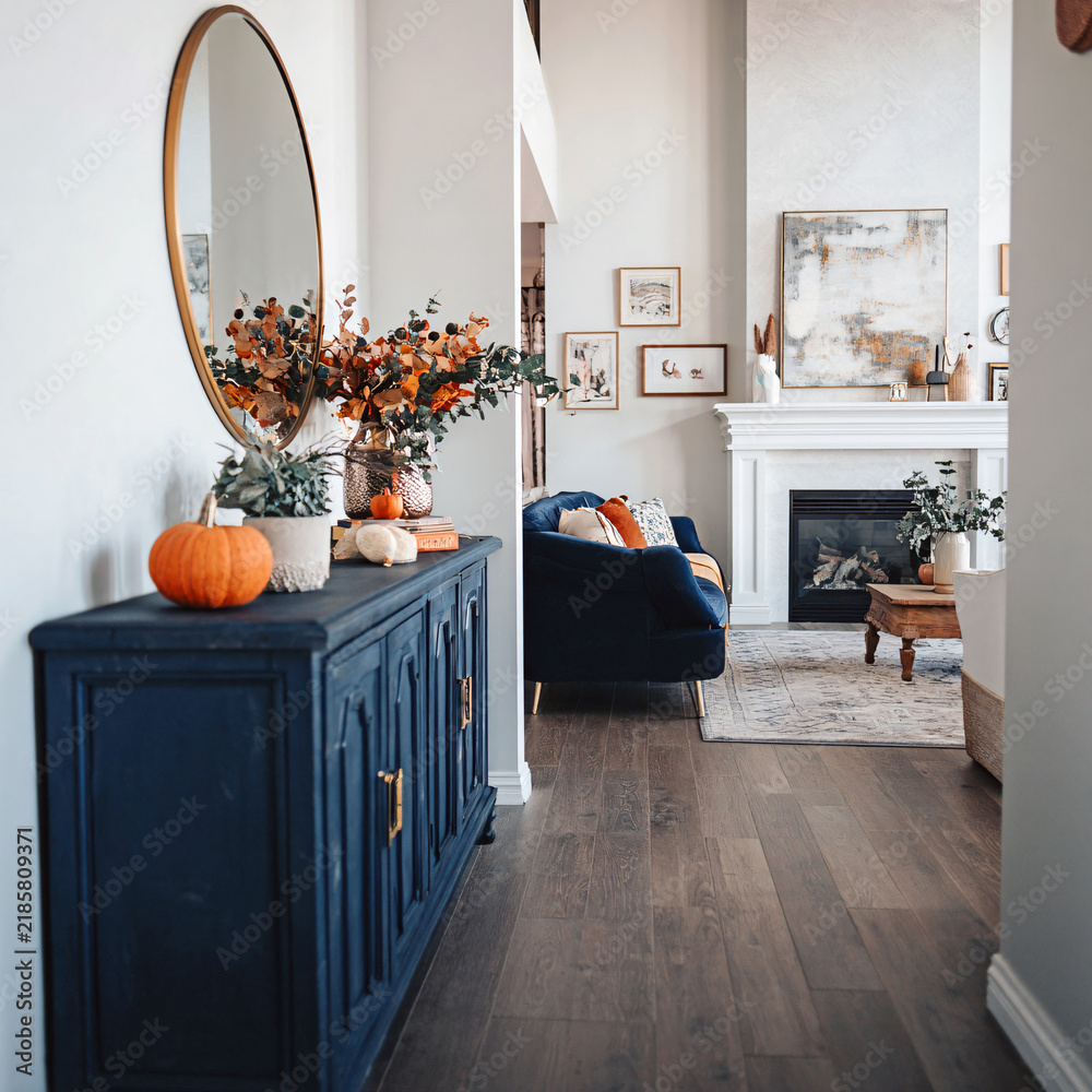 Obraz premium Cozy autumn home interior with elegant decor, pumpkins, and a welcoming fireplace scene