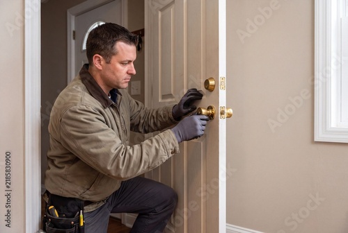 Skilled Technician Mounting Residential Door Hardware in Home Interior