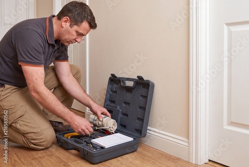 Professional Contractor Preparing Repair Equipment for Residential Door Maintenance
