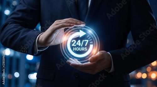 A business professional holds a glowing digital orb displaying 24 7 with a blurred city background representing constant connectivity