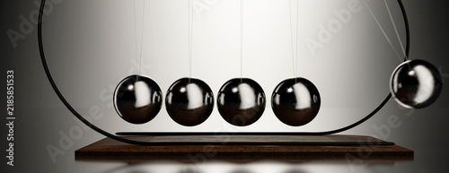 Foto Newton's Cradle demonstrating kinetic energy transfer and conservation laws