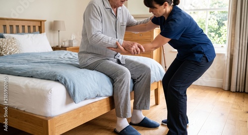 Caregiver assists an elderly man to sit up in bed