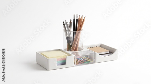 Minimalist desk organizer with stationery, white office supply holder with pens and sticky notes, modern workspace storage