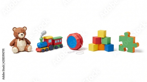 Row of 3D low poly papercraft toy figures including teddy bear, steam train, yo-yo, building blocks, and puzzle piece isolated on white background. Ideal for kids play, nursery, and craft themes.