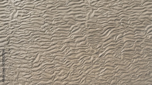 Abstract textured beige background with wavy lines