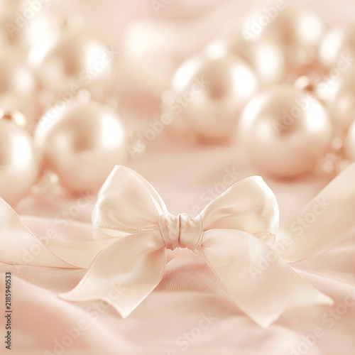 Square coquette-style winter background with cream pearls and a soft sati