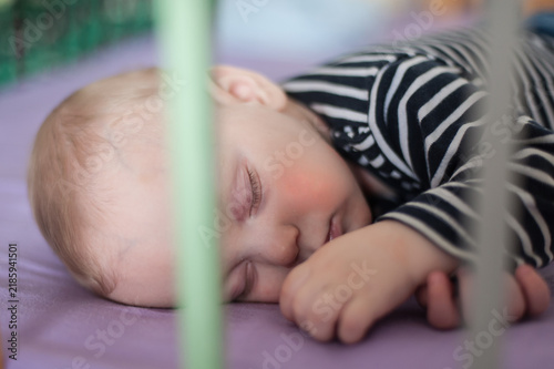 Konstfotografi Peaceful baby sleeping soundly in a crib during the afternoon light