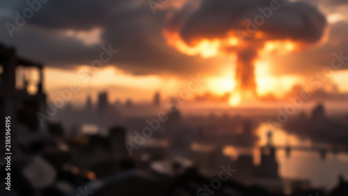Blurred view of a giant nuclear mushroom cloud and explosion over a city skyline at sunset