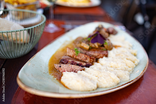Konstfotografi Gourmet sliced beef steak served over creamy potato puree, topped with mushroom