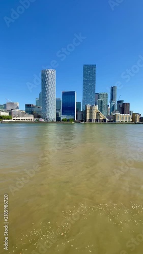 London River Thames below Canary Wharf skyscrapers Docklands homes