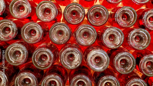 Cuadro en lienzo Red wine bottles densely stacked in horizontal rows, displaying their glass bott