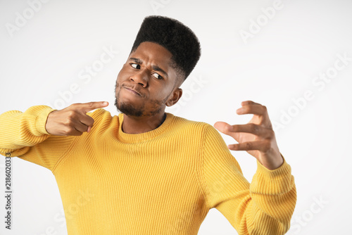 Картината върху платно Portrait of angry young man clenching fists and shouting isolated over white bac