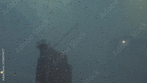 Close Up of Rain Drops on Window With Blurred City Background