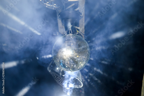Obraz na plátně Sparkling disco ball reflecting bright lights in a dark nightclub or party venue with dynamic motion blur effect