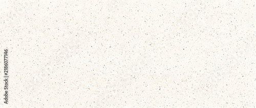 Terrazzo texture background featuring white surface with scattered gray and beige stone chip speckles for interior design projects