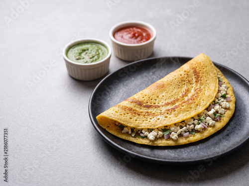 Crisp golden-yellow moong dal chilla stuffed with paneer