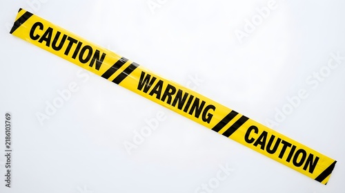 Caution Warning Tape Strung Across Light Background