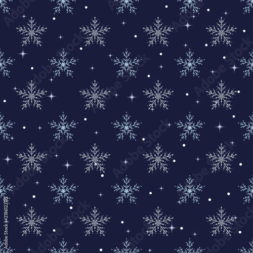 Seamless winter pattern featuring delicate, intricate white snowflakes scattered gracefully across a rich dark navy blue background