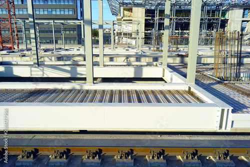 Konstfotografi Reinforcement mesh grid on concrete platform beside railway track with steel columns beyond