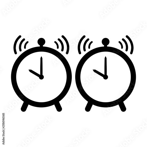 Two black and white alarm clocks ringing loudly side by side