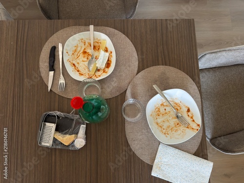 Canvastavla Overhead view of empty dinner plates, cheese, grater, utensils, glasses and napkin on a dining table