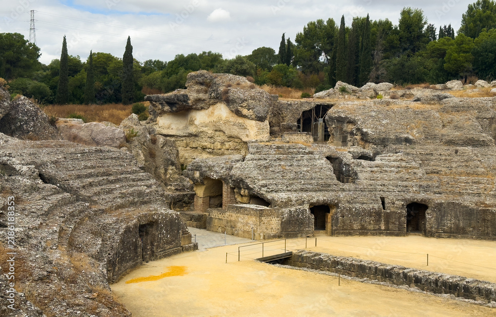 Obraz premium The arena in the amphitheater of Italica, an archaeological site at the outskirts of Seville 