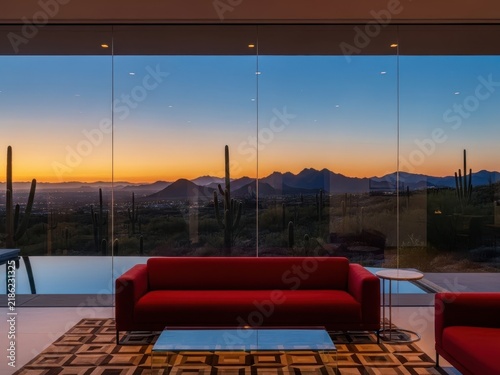 Modern red couch with sunset view through large windows