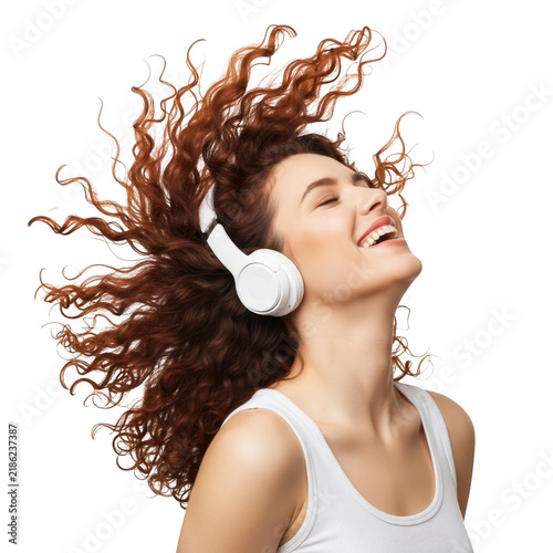 Woman laughing with headphones while enjoying music