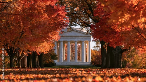 Autumn leaves frame neoclassical memorial building with warm sunlight during peak foliage season