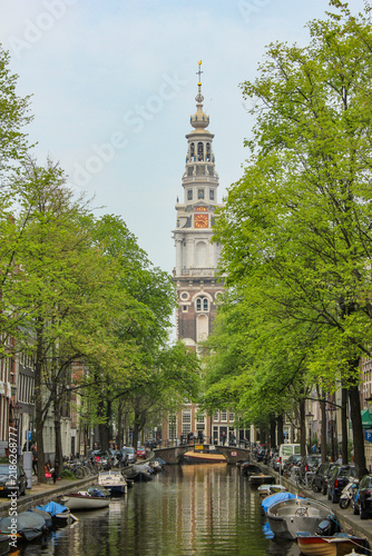 The Zuiderkerk (South Church) towering over the Groenburgwal canal in the historic heart of Amsterdam, Netherlands