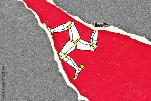 Fotografie Isle of Man Flag Triskelion Symbol Ripped on Textured Grey Background Representi
