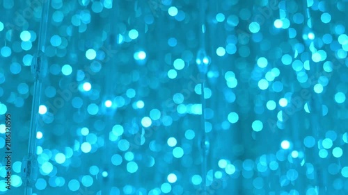 Large Flickering Blue Light Bokeh, Abstract Neon Background.
Large glowing blue light bokeh particles flickering against a dark background, creating a dynamic abstract neon atmosphere.