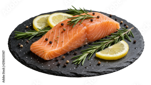 Raw salmon fillet seasoned with peppercorns and herbs served with lemon slices on slate, isolated on transparent background