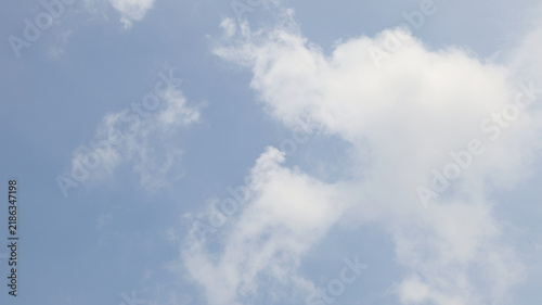 A clouds scattered across a light blue sky