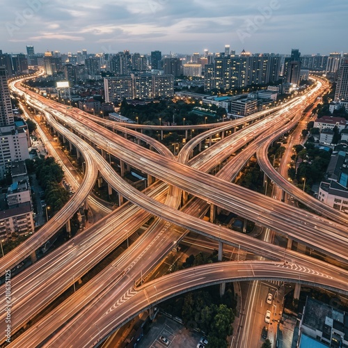 Captivating Aerial View Of A Sprawling Urban Highway Interchange At Dusk