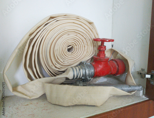 Fire protection cabinet with fire hydrant and rolled hose. is it in a store or other public place