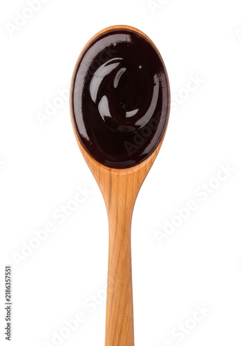 Wooden spoon with dark syrup or sauce