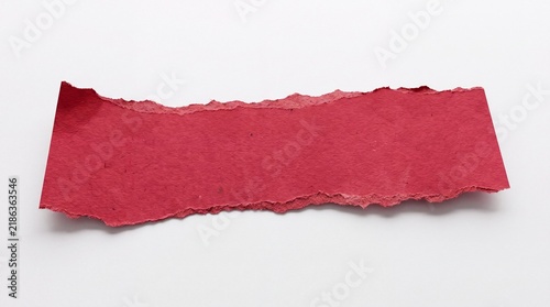 A vibrant red piece of torn paper on a clean white background
