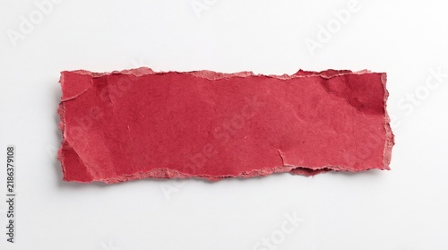A vibrant red piece of torn paper on a clean white background