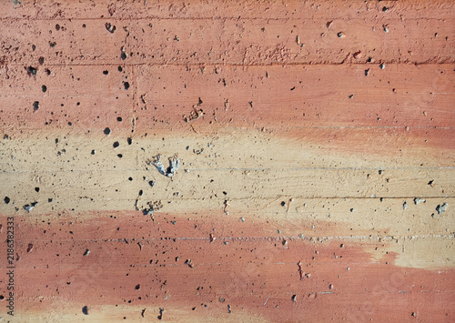 Aesthetic textured concrete wall with pink and yellow gradient