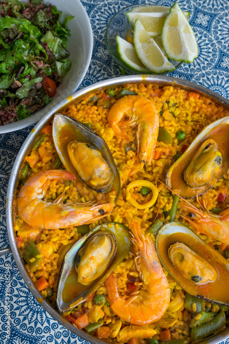 Seafood paella, salad and lemon